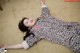 A woman laying on the floor with her arms outstretched.