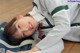 A young girl laying on the floor with a backpack.