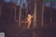 A naked woman standing in the woods with the words SMART.